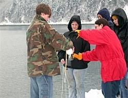 Youth Area Watch students learning how to collect water samples for laboratory testing